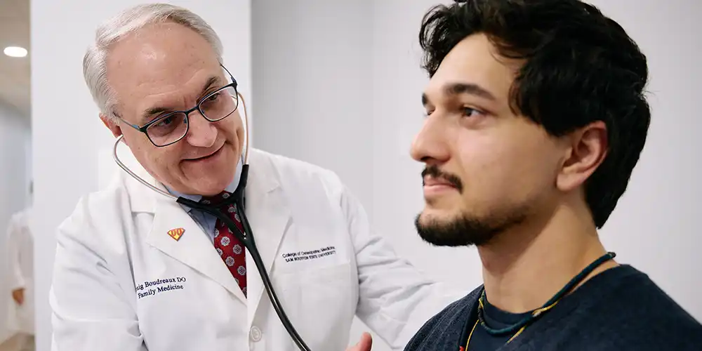 Doctor giving a male patient a health screening