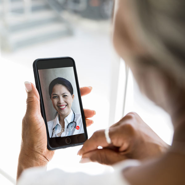 woman using cell phone to call doctor