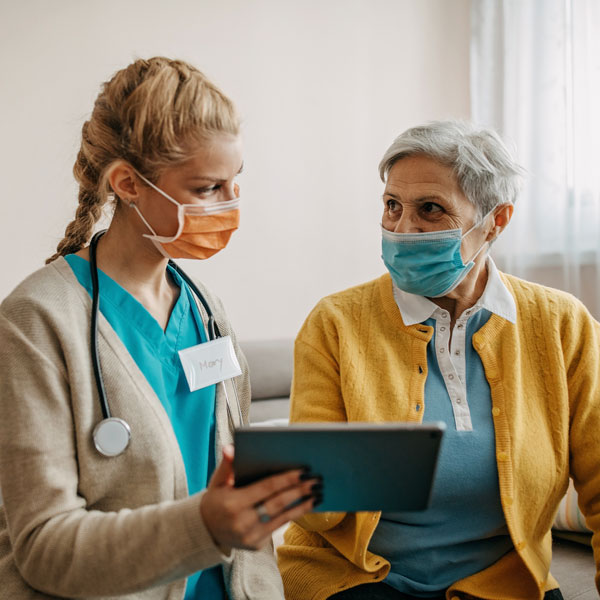 nurse talking to elderly patient