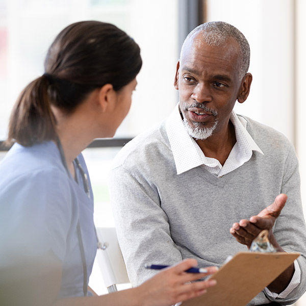 A Man and Doctor Discussing Osteopathic Manipulative Medicine in Conroe, TX
